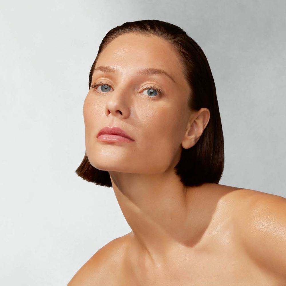 Frau mit nackten Schultern blickt frontal